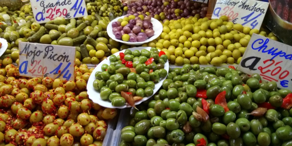 Stall selling olives at Atarazanas Market, a great place for shopping in Malaga