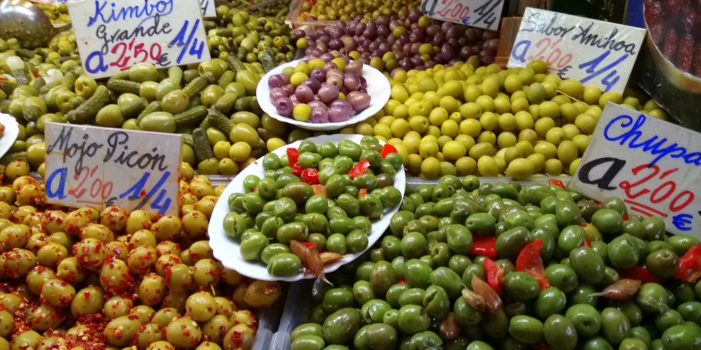 Stall selling different types of olives at Malaga market